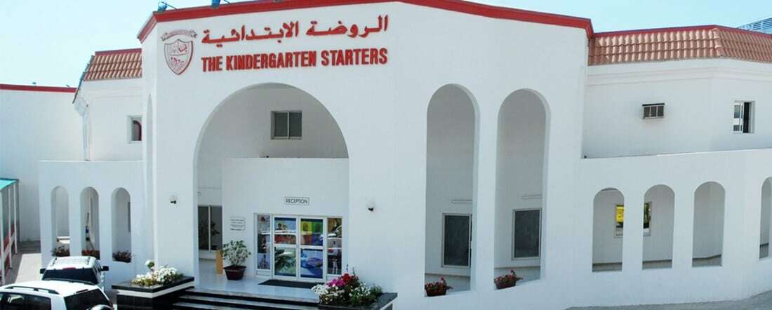 a-kindergarten-school-building-in-the-uae-white-washed-walls-and-english-teacher-standing-outside